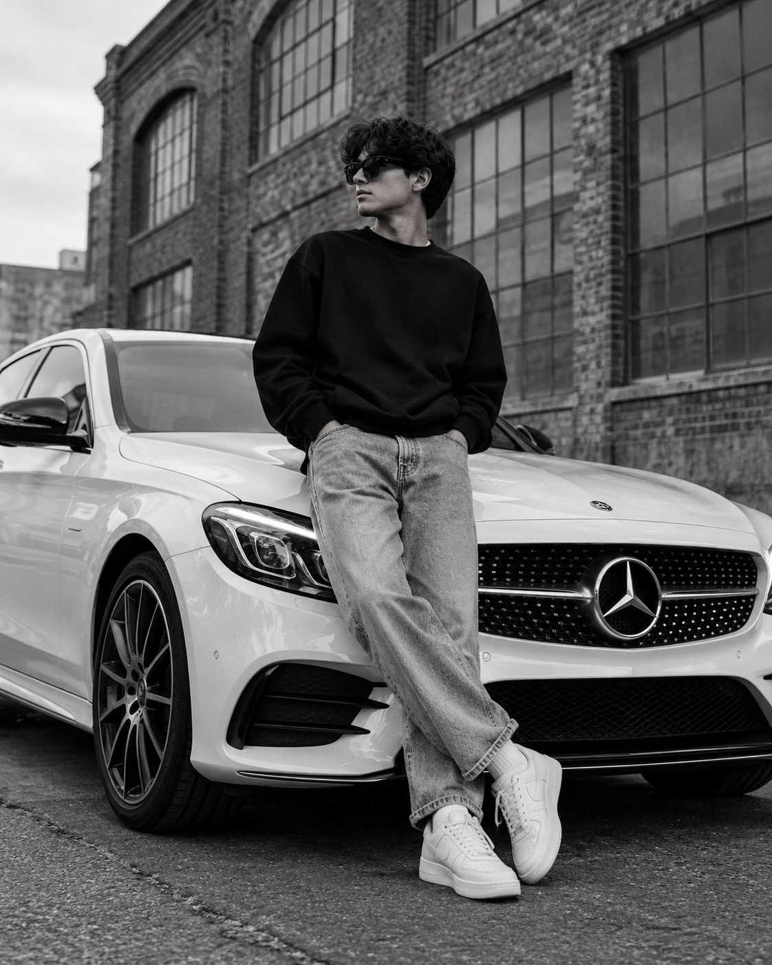 Black and white AI fashion portrait of a stylish young man wearing sunglasses and streetwear while leaning against a white Mercedes-Benz luxury car.